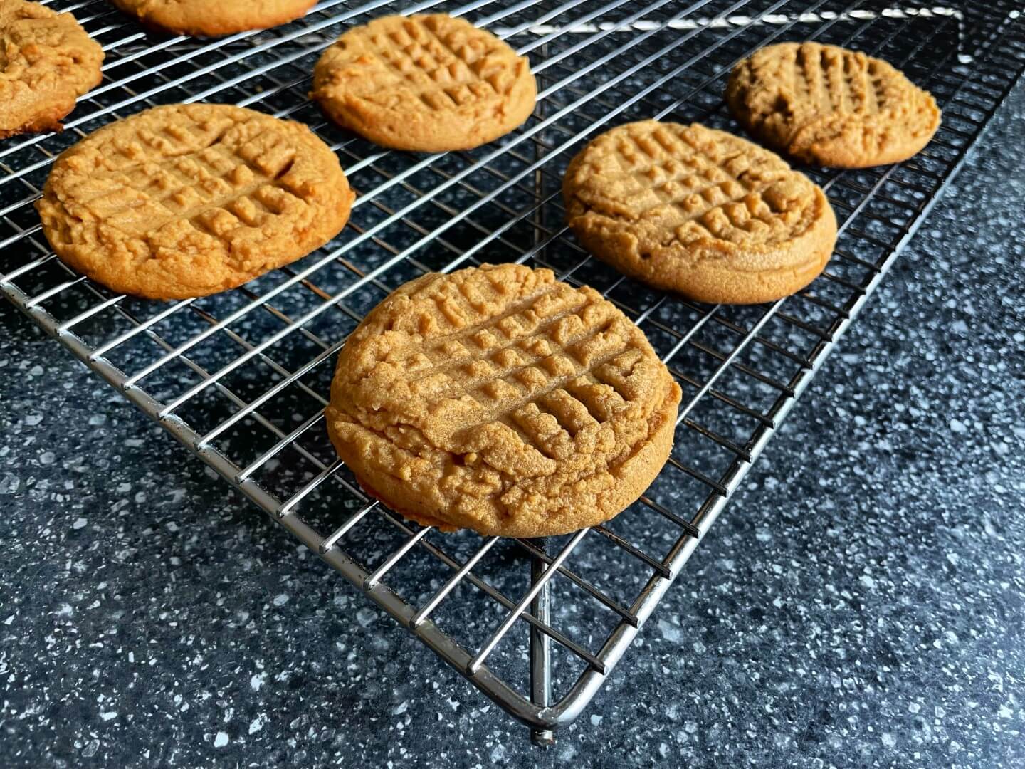 Baked Peanut Butter Cookies on a wire rack.